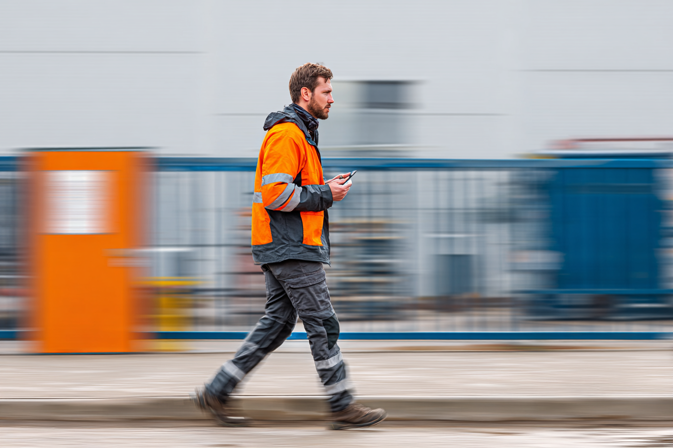 impulsmedia_imagine_a_site_entrance_to_a_industry._a_worker_i_c499de13-7817-4029-b639-c4633c1b9463_0 Bauarbeiter Baustelle Smartphone
